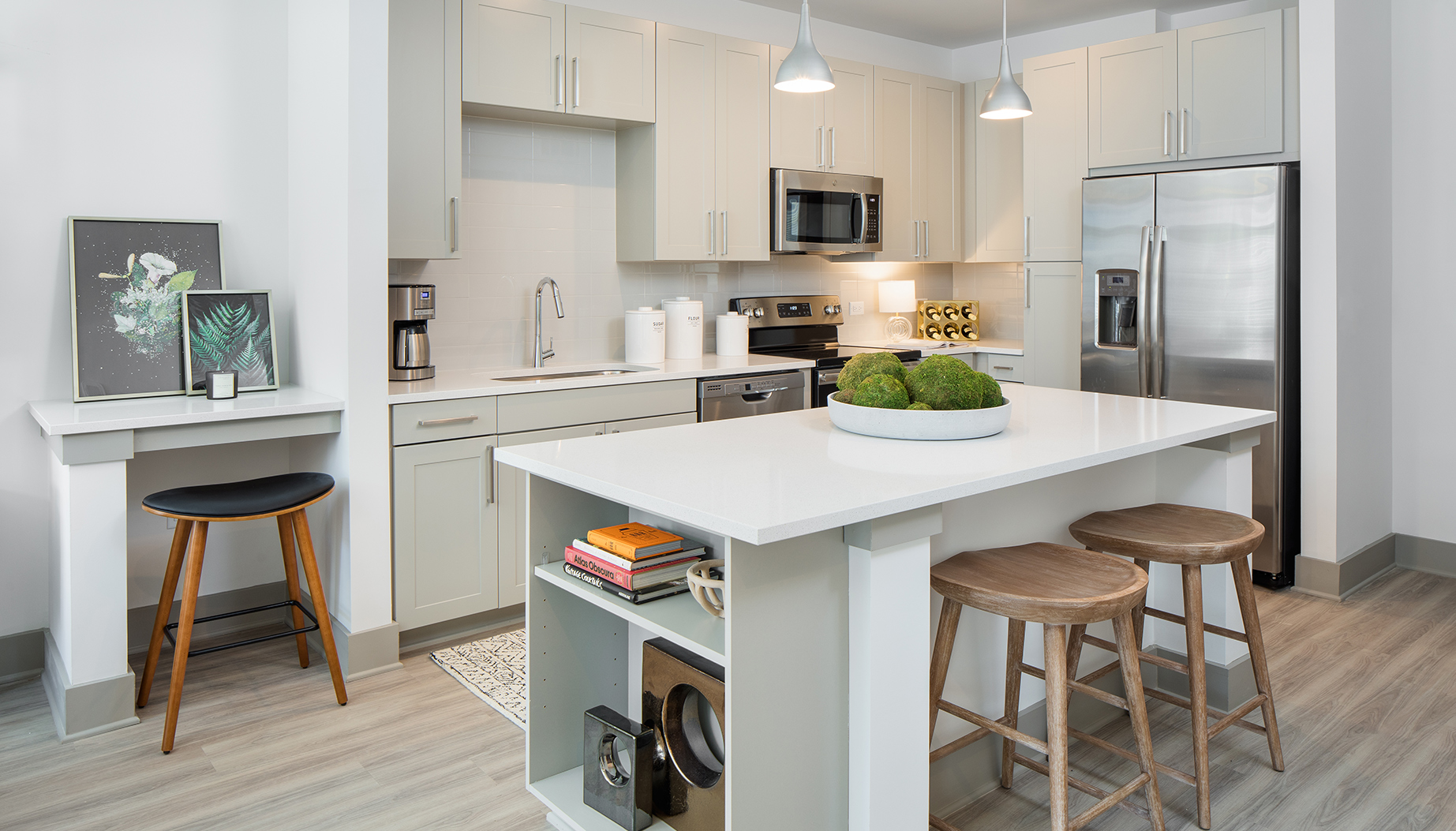 Vine North Hills kitchen with island and desk space, white cabinets and white countertops with silver appliances