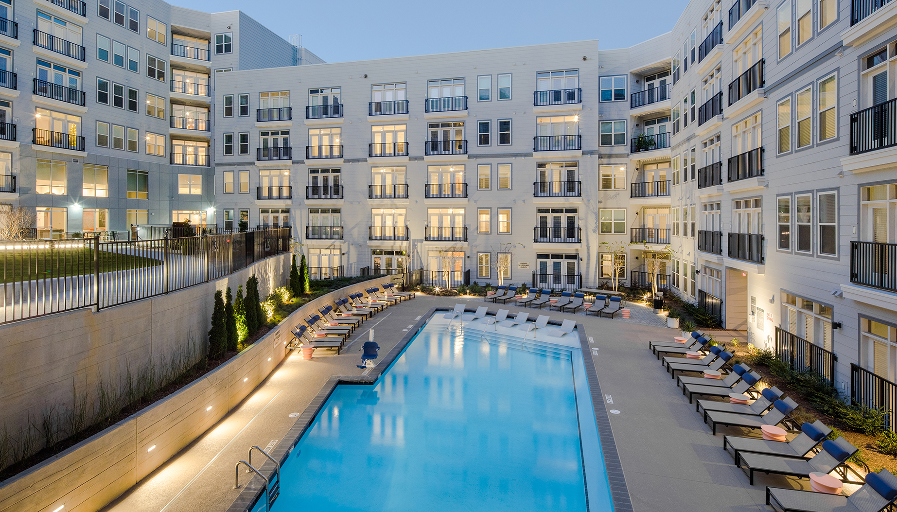 Vine North Hills pool during dusk with the lights on