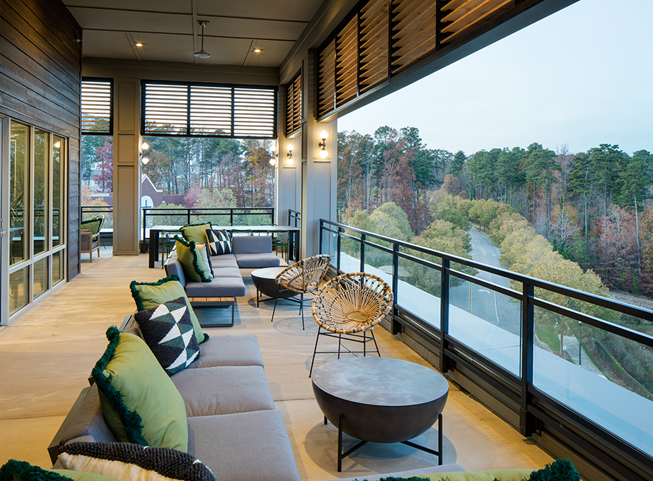 Vine North Hills rooftop terrace with seating and view of trees