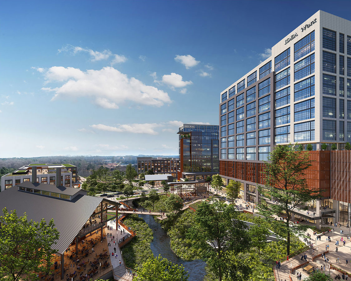 North Hills Innovation District exterior view during the day with many people utilizing the space and a view of high rise buildings